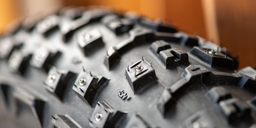 a close up detail of a stud in a studded bike tire