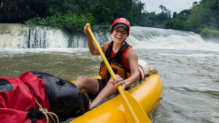 A rafter paddling in a river.