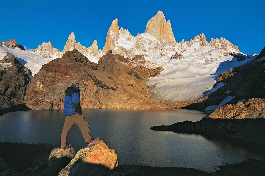 Man and a lake in front of Fitz Roy in Patagonia.