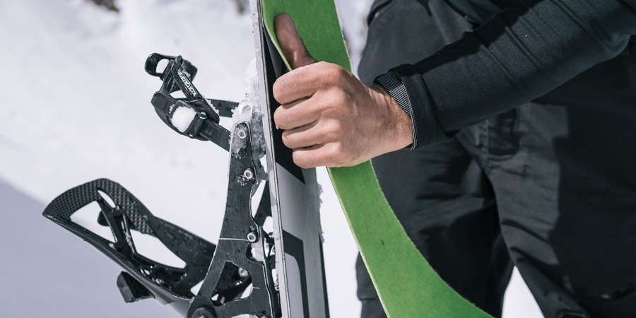 A skier applying skins to his skis