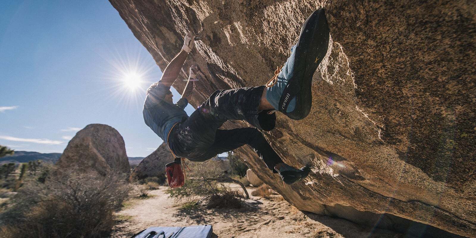 A climber practices their holds a few feet off the ground.