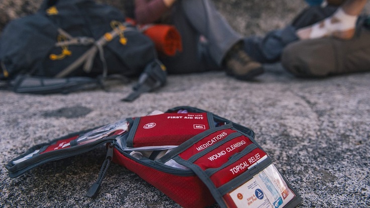 Open first aid kit on the ground