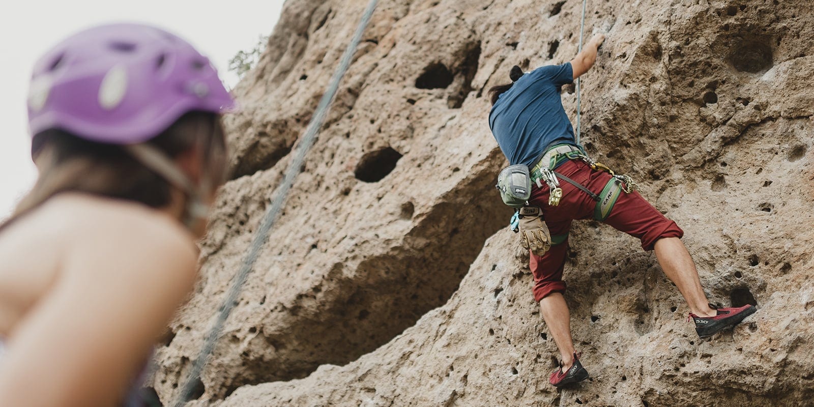 Rock climbers scaling a cliff. 