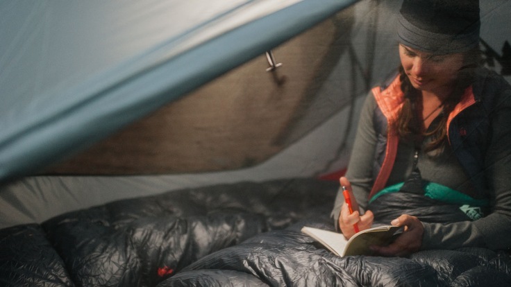 a camper in their tent at night