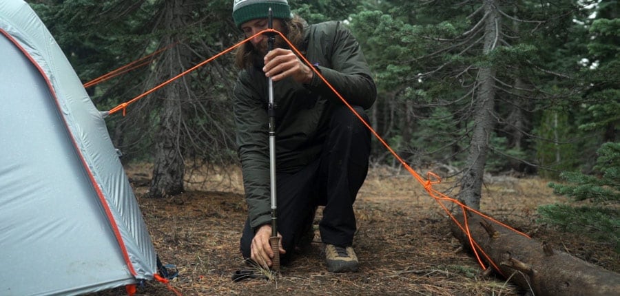 guying out a tent with a trekking pole