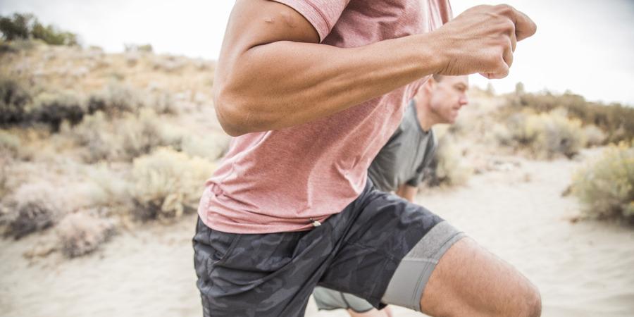 a trail runner with relaxed fists and arms perpendicular to torso