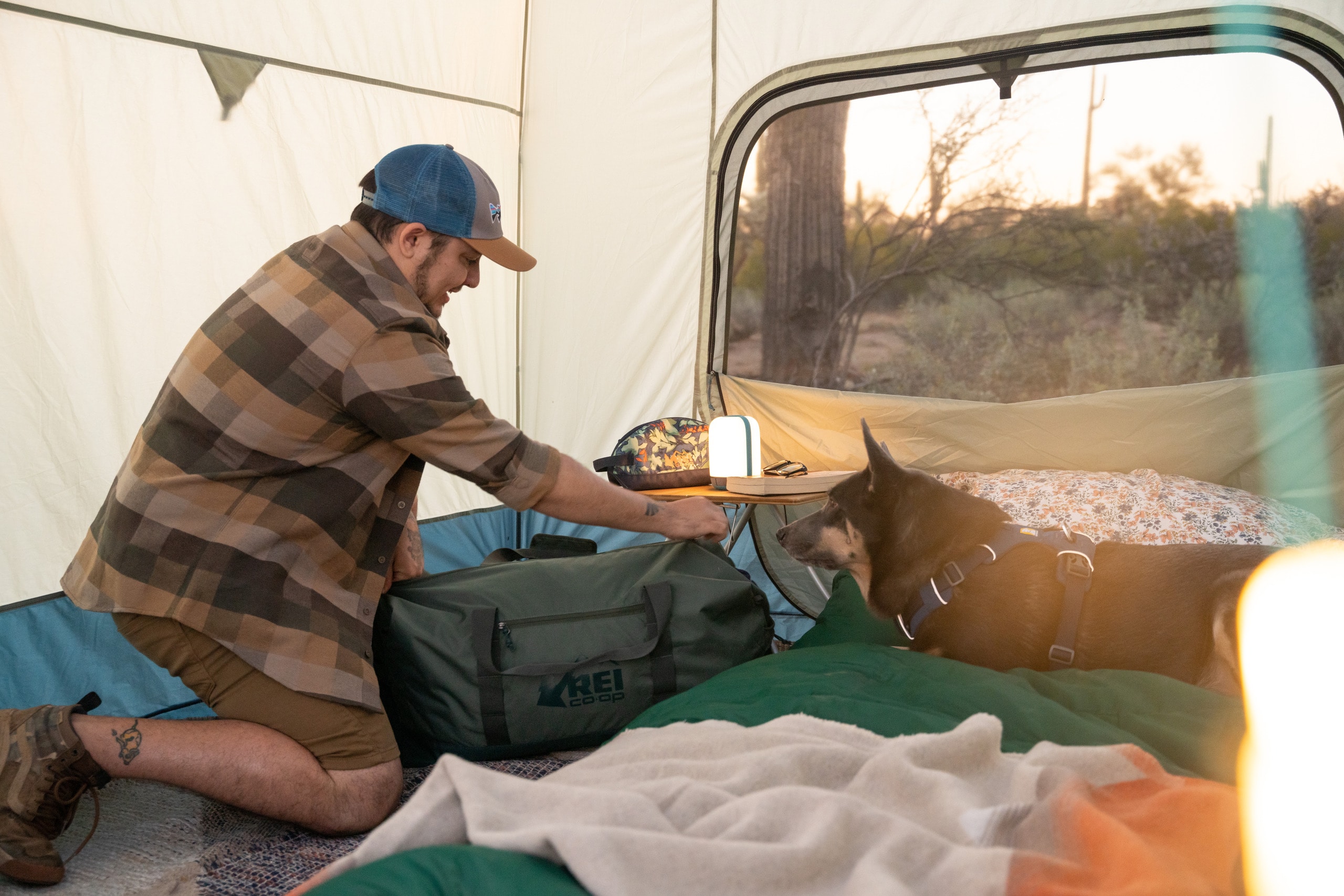 A man packs his gear inside his tent