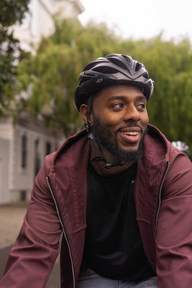 Man wears bike helmet while cycling