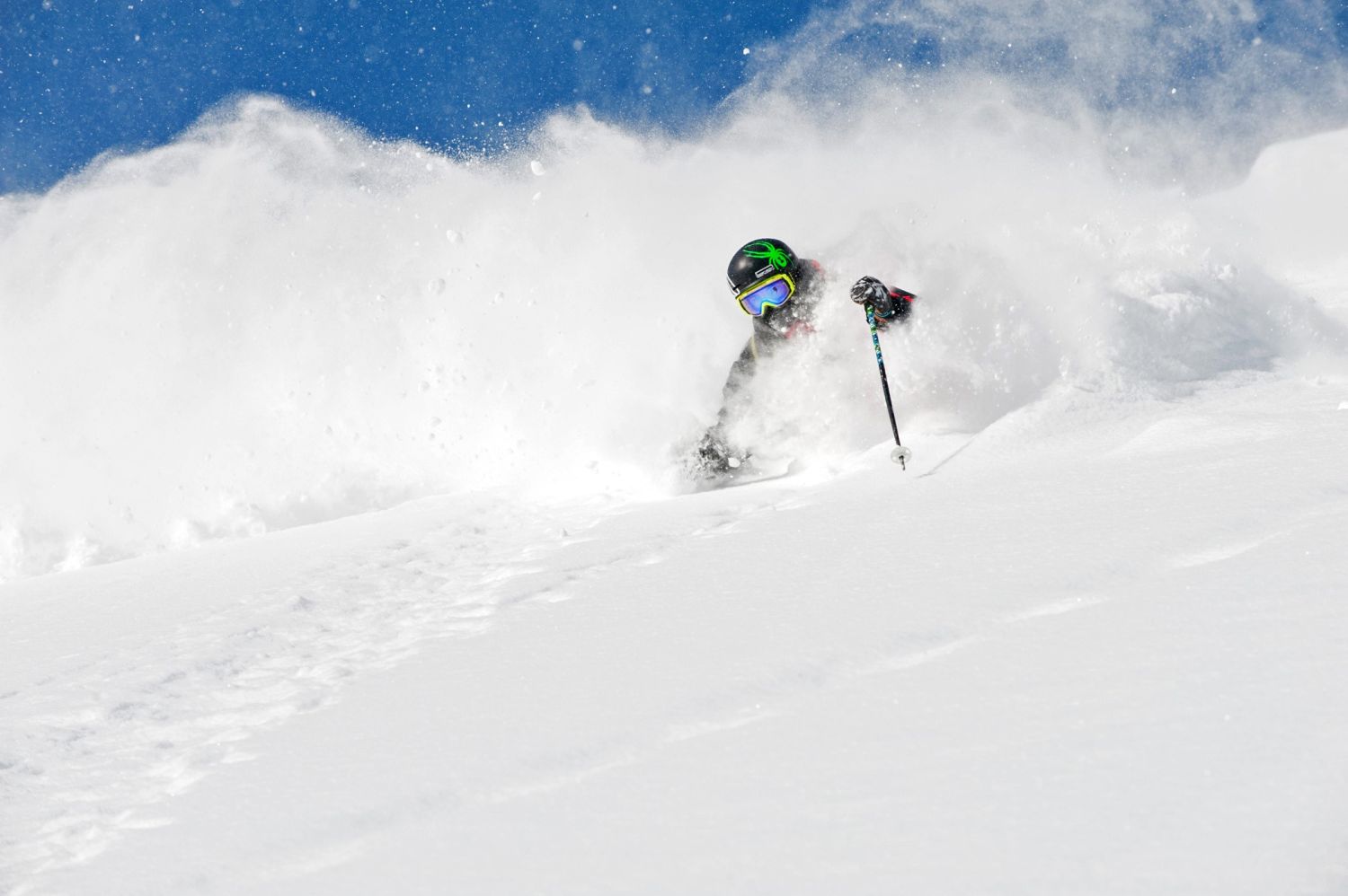 A skier sends up a powder cloud
