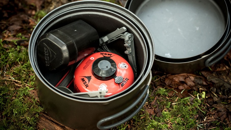 A camp stove with a fuel canister.