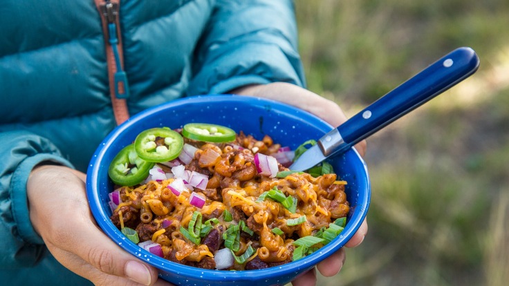 Chili mac in bowl at campsite