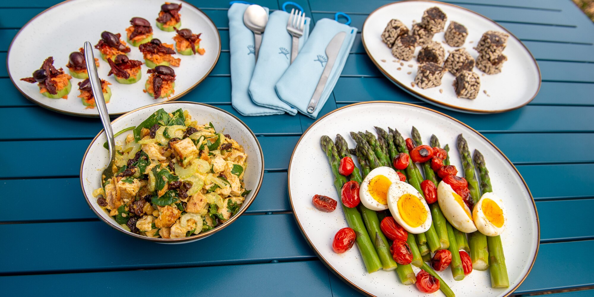 A buffet of outdoor dishes made with fresh fruits and veggies