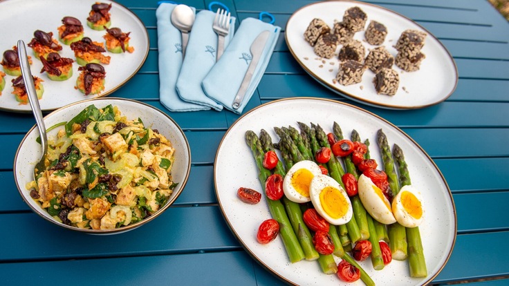 A buffet of outdoor dishes made with fresh fruits and veggies
