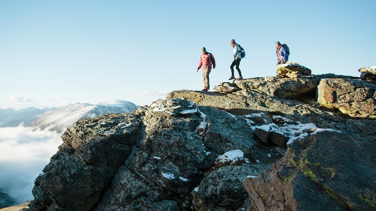 3 hikers on top of a mountain