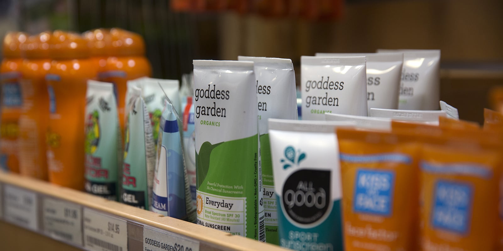 A shelf full of sunscreen products in an REI store