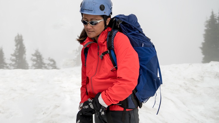 a mountaineer layered up and on the snow field