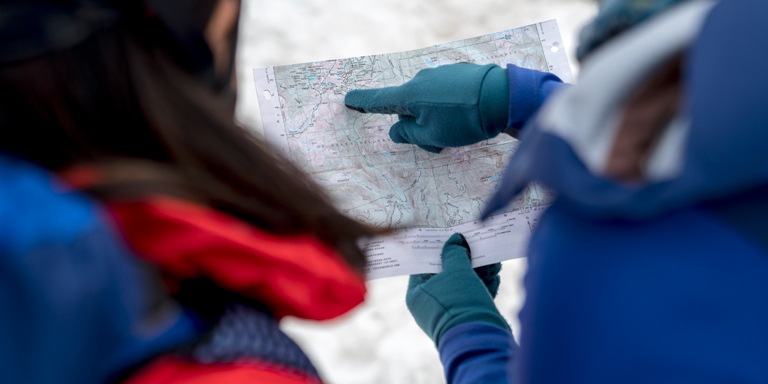 Two mountaineers look at a topographic map