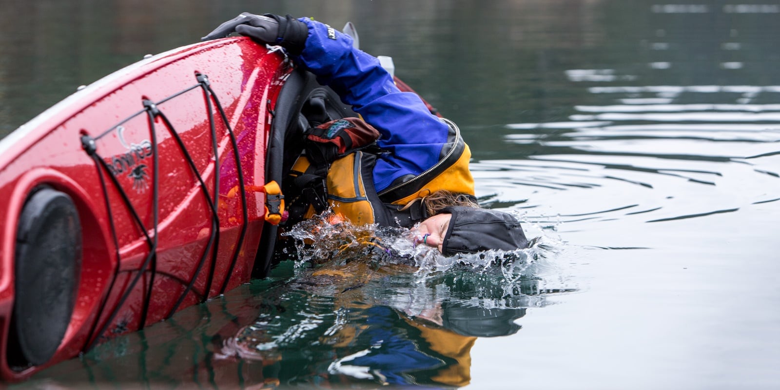 Instructor mid flip in his kayak