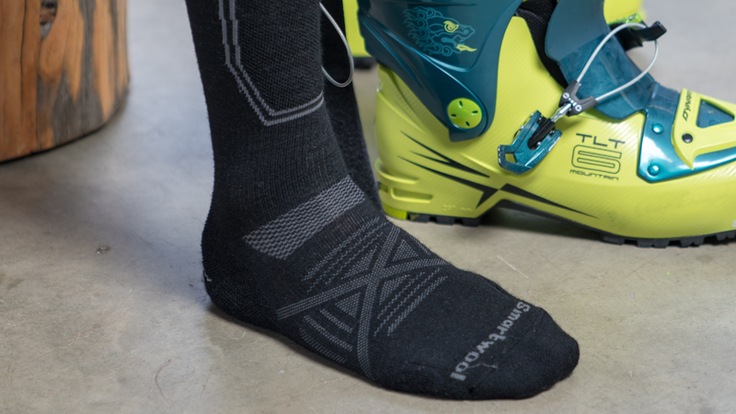 skier putting socks on