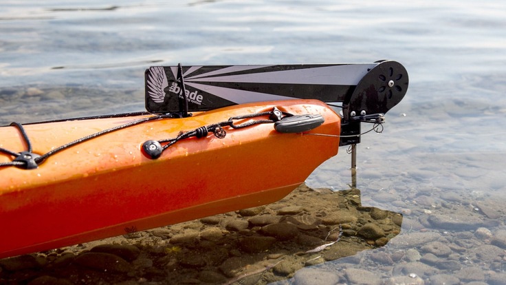 A detail shot of the stern of a kayak sitting in the water with the rudder in the un-deployed position