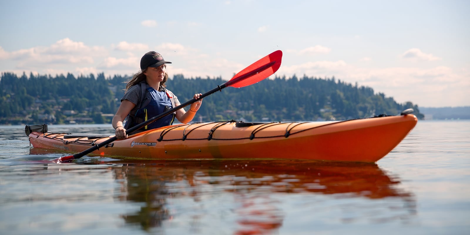 a woman paddling a kayak