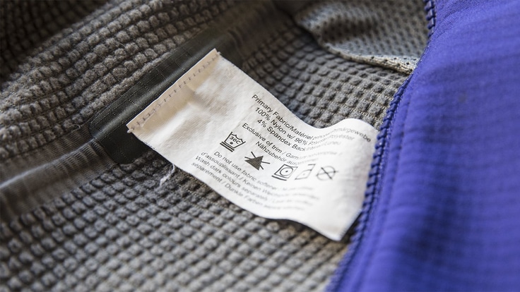 A closeup image of a fabric care tag attached to a garment