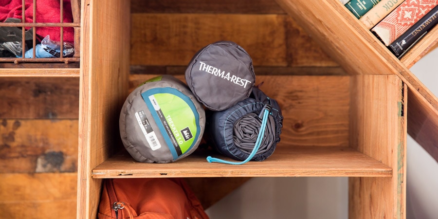 Sleeping pads being stored on a shelf