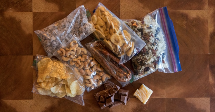 a collection of foods, in plastic bags, for an ultralight backpacking trip