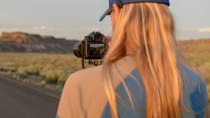 a photographer adjusting setting on their camera