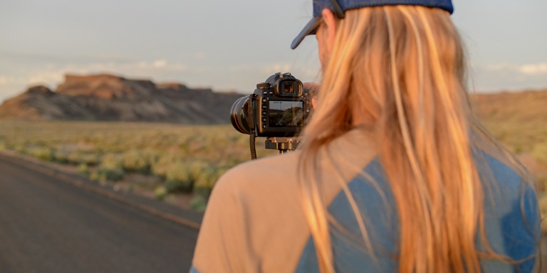 a photographer adjusting setting on their camera