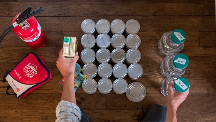 a person taking inventory of their emergency preparedness kit