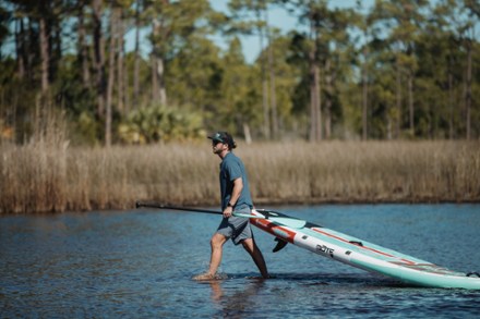 paddleboarder carrying a board