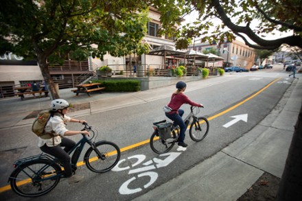 man and women riding with step through electric bikes on a bicycle road