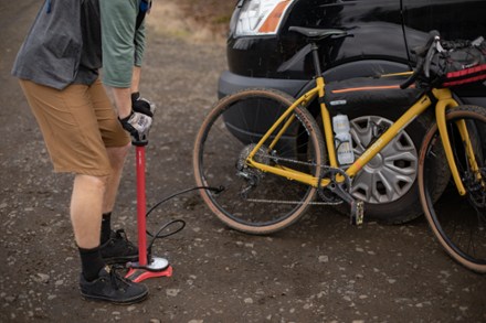 mountain biker pumping bicycle tires before a ride