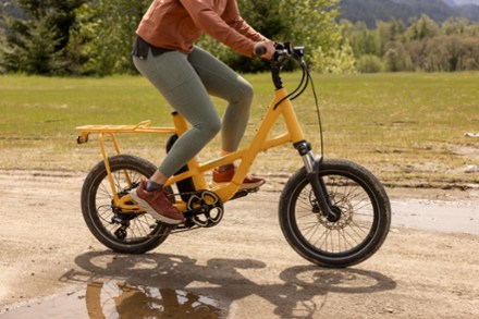 female cyclist riding yellow generation e.1.1 bike