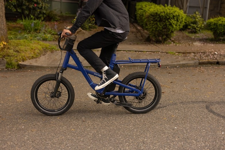 man riding blue electric bike