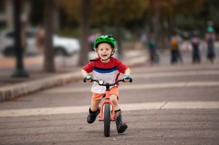boy running on a balance bike