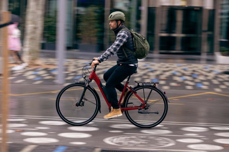 man riding ebike dressed in neutral colors