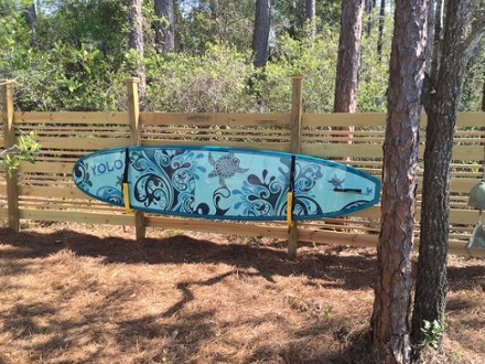 paddle board storage rack on the fence