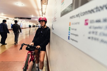 woman cyclist with a pink bike helmet